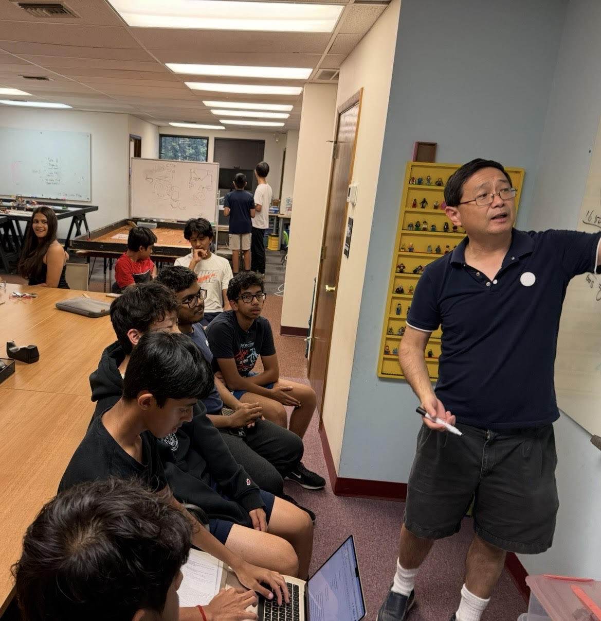 Mentor teaching team members in workshop setting