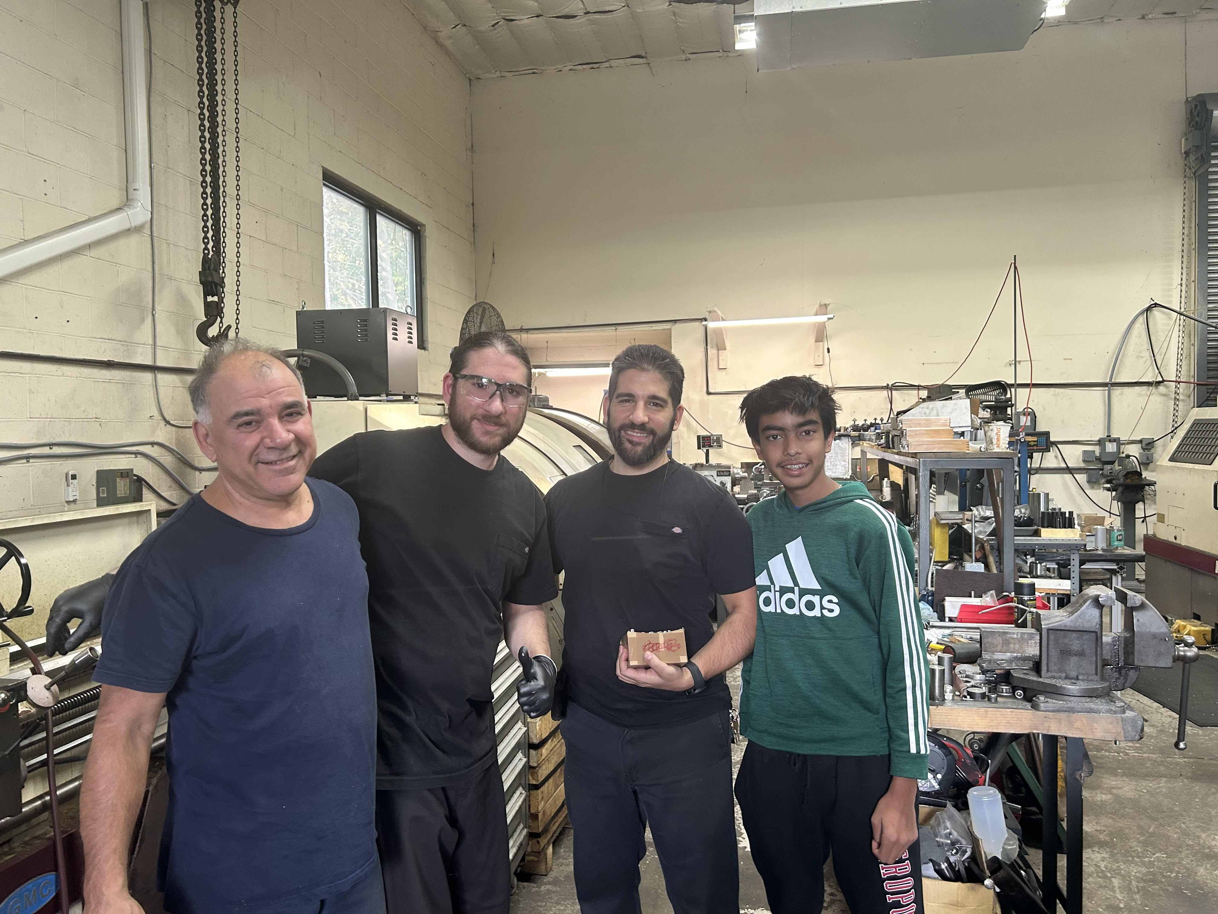Team members with sponsor representatives in workshop